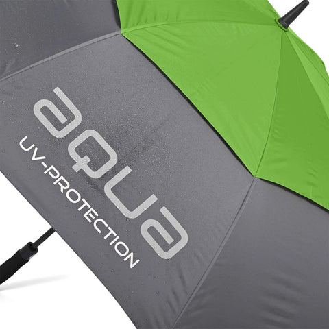 A green and gray umbrella displays the text aqua UV-PROTECTION while raindrops rest on its surface indicating use in wet weather conditions.