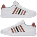 A pair of white sneakers features three horizontal stripes in brown black and light brown on each side and has a tan suede heel tab positioned at the back