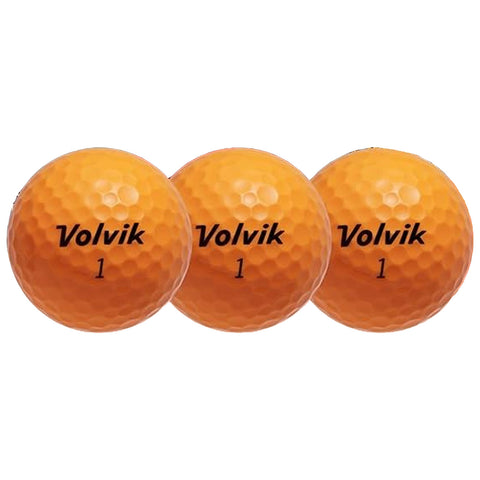 Three orange golf balls are arranged in a line displaying the brand name Volvik and the number 1 on their surfaces against a plain background.