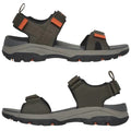 A pair of outdoor sandals with adjustable straps features a textured sole for grip and a supportive footbed designed for comfort during walking or hiking in rugged environments.