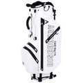 A white golf bag stands upright featuring multiple zippered pockets and a prominent logo. It is designed for carrying golf clubs and accessories, suitable for use on a golf course.