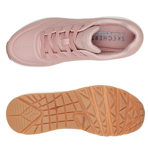 Light pink sneakers with a perforated design and matching shoelaces are displayed from a top view and underside, showcasing the textured rubber sole in a contrasting tan color.