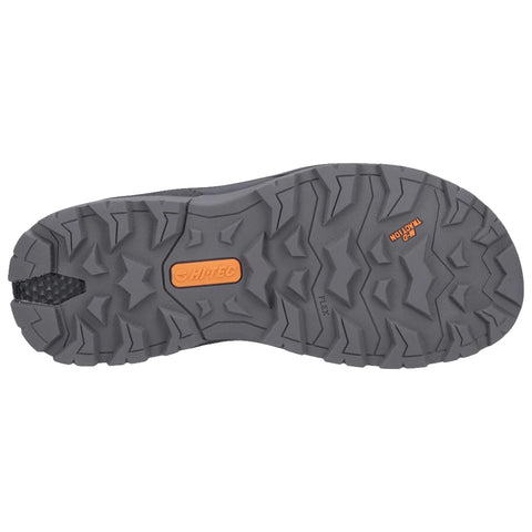 A shoe outsole designed for traction features a rugged rubber surface with various protrusions and patterns for grip during outdoor activities situated against a plain background.