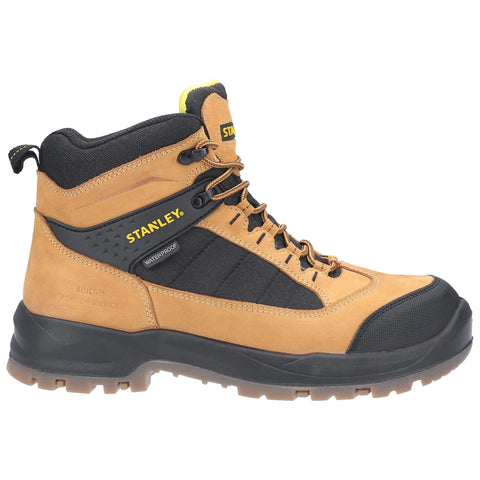 A brown and black waterproof boot is displayed standing upright featuring laces and reinforced toe cap showcasing the STANLEY logo and the phrase BUILT IN PERFORMANCE on the side.