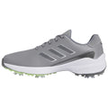 Gray athletic shoe features a textured upper and three parallel stripes on the side while the sole has protruding spikes designed for traction on grass surfaces.