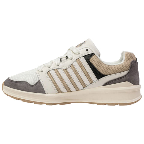 A sneaker showcases a white and cream upper with gray and black accents laced up against a plain background highlighting its sporty design and versatile color scheme.