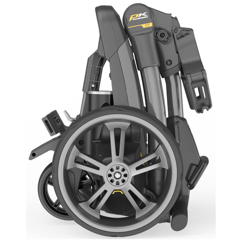 A compact folding wheelchair features large wheels and a streamlined frame is positioned vertically indicating readiness for storage or transport in a clean background environment.