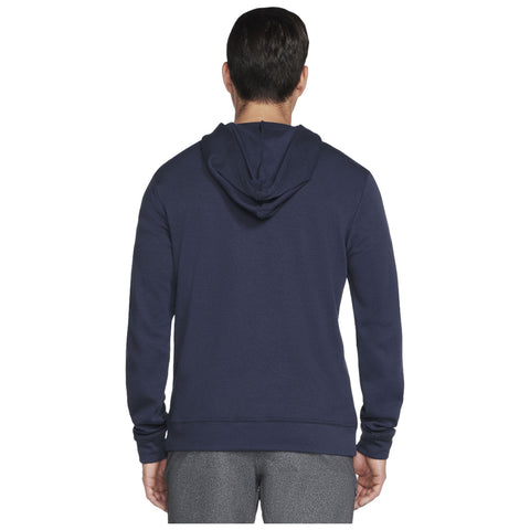 A person wearing a navy blue hoodie is standing with their back facing the viewer in a neutral background, showcasing the texture and fit of the garment.