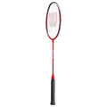 A red badminton racket stands upright with a black grip handle and a mesh stringed head designed for striking shuttlecocks in indoor or outdoor play settings.