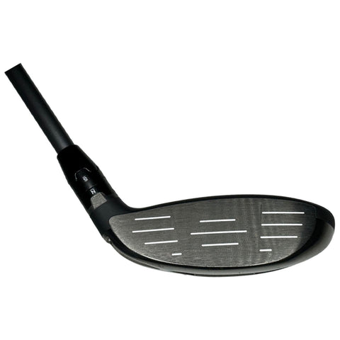 A golf club head is angled slightly with a flat striking surface featuring etched lines and a sleek black finish the context suggests it is positioned for a swing on a golf course