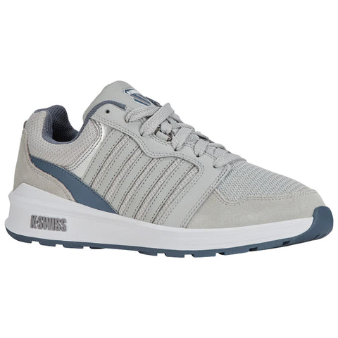 A grey athletic shoe features a combination of mesh and suede materials with accent lines. The shoe is positioned at an angle against a neutral background.