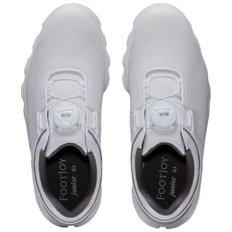 White golf shoes designed for juniors feature a sleek, streamlined shape with a BOA lacing system on the top, situated against a neutral background for focus.