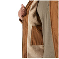 A brown jacket is partially unzipped revealing a plush cream-colored lining and a pocket on the inside while a hand holds the jacket open in a neutral setting.