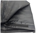 A folded black fabric item displays a zippered section revealing a smooth interior texture situated against a neutral background suggesting storage or organization purposes.