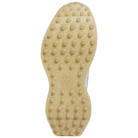 A shoe sole is displayed with a textured surface featuring numerous round and hexagonal studs for grip and traction designed for sports or outdoor activities.