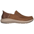 Brown slip-on shoes with a cushioned sole rest against a white background highlighting their smooth leather finish and textured heel design suitable for casual wear and comfort.