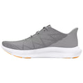 A grey athletic shoe features a textured upper with striped patterns and a thick white sole with an orange accent that indicates it is designed for performance and comfort.