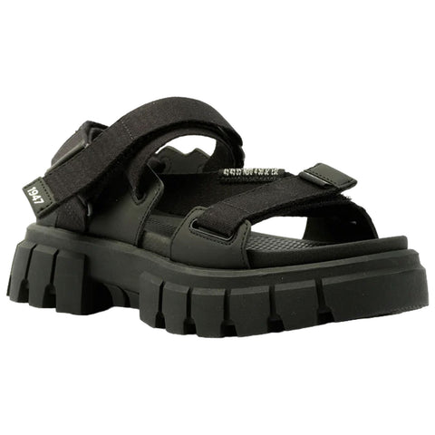 A black sandal features thick straps and a chunky sole designed for durability. It is positioned against a plain background, suggesting a focus on style and functionality.