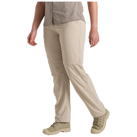 A person is walking in light, zip-off pants and sturdy shoes. The setting suggests an outdoor environment, suitable for casual or hiking activities, emphasizing comfort and mobility.