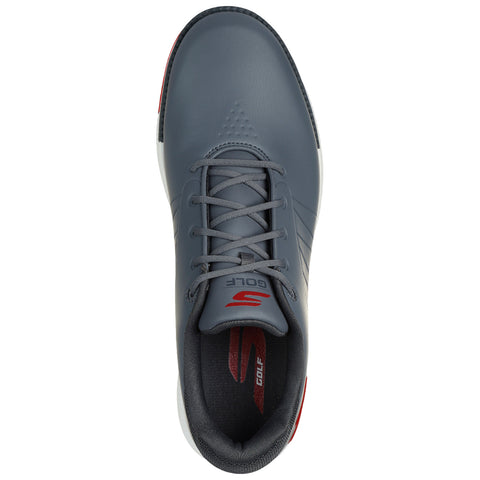 A grey golf shoe features a smooth upper and a white sole with red accents laces are tied positioned on a neutral background highlighting its design and purpose.