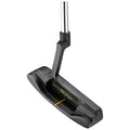 A black golf putter rests upright with a shiny silver shaft and a flat head featuring a yellow alignment line and a textured surface for precision in putting on a green.