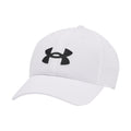 A white baseball cap with a black Under Armour logo prominently displayed on the front resting on a plain background showcasing its design and brand identity