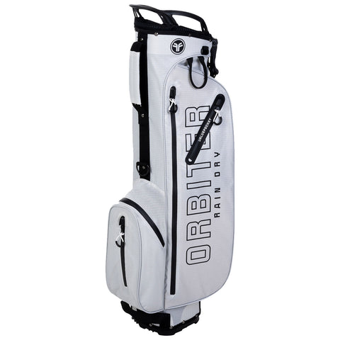 A golf stand bag is upright featuring a sleek gray design with large black lettering reading ORBITER RAIN DRY and multiple zippered compartments for storage in a neutral setting.