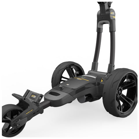 A black golf trolley is positioned upright with large wheels and a central body featuring controls and a storage compartment all set against a plain white background.