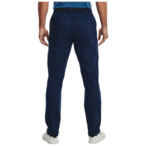 Navy golf chinos are being worn by a person facing away from the viewer with a hand resting at their side in a casual setting, perfect for outdoor activities such as a day on the golf course.