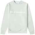 A mint green sweatshirt features the word Humanrace prominently displayed in white across the chest which appears textured against the smooth fabric background