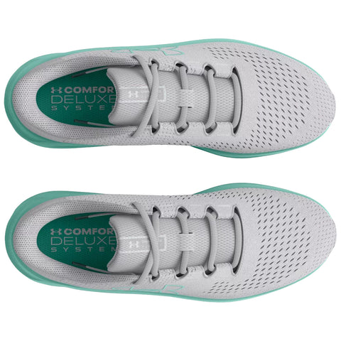 Gray athletic shoes with a mint green sole are displayed from a top-down view showcasing perforated upper material for breathability and a cushioned insole labeled as Comfort Deluxe System.