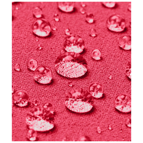 Water droplets gather on a textured pink fabric surface showcasing a close-up view of the interplay between liquid and material in a vivid, colorful context.