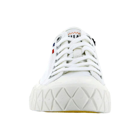 A white sneaker with a textured sole is displayed frontally featuring laces and eyelets The sneaker includes small colored logos on the side and a prominent tongue design