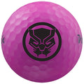 A pink golf ball features a prominent black graphic of a stylized animal face surrounded by a circular border sitting against a neutral background.