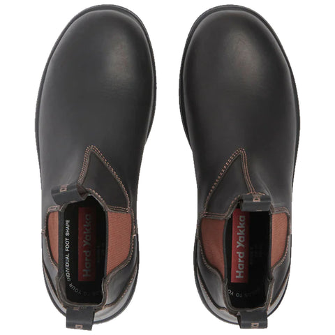 Black leather boots with elastic sides are positioned side by side displaying a smooth surface and contrasting brown sections at the ankle area set against a neutral background.