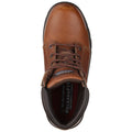 A brown leather shoe sits on a flat surface featuring laces and a relaxed fit associated with comfort indicating it's designed for casual or work settings.