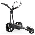 A black Powkaddy FX1 golf cart stands upright featuring three large wheels a handle and a holding area for golf clubs showcasing a sleek modern design suitable for use on a golf course