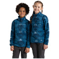 Two children stand side by side wearing matching blue mid-layer fleece tops with a geometric pattern. They are smiling and posed against a plain white background.