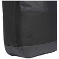 A black sports bag made of durable fabric features a textured surface and a gray base The bag showcases a subtle three-stripe logo on its side