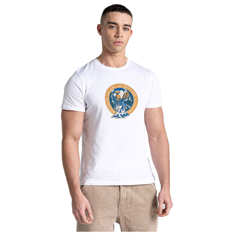 A young man stands in a white t-shirt featuring a colorful graphic on the front that reads OUTDOOR CLIMBING GO EXPLORE surrounded by a circular design with imagery of climbing and nature.