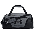 A grey duffel bag with a prominent black Under Armour logo sits flat on a surface featuring double zippers and a detachable shoulder strap designed for carrying sports gear or personal items.