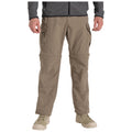 Lightweight cargo pants with multiple pockets are worn by a person standing upright who is wearing a dark jacket and light shoes in a neutral setting.