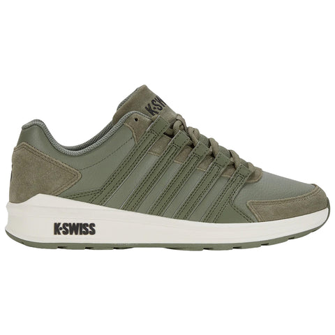 A green athletic shoe is displayed featuring a smooth leather and suede exterior with multiple stripes on the side showing the brand K-Swiss on the heel and sole.