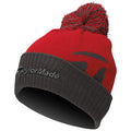 A red and gray knit beanie sits upright with a pom-pom on top displaying the TaylorMade logo in gray on the cuff, suggesting warmth and style for cold weather conditions.