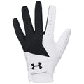 A golf glove with a white leather palm and black textured fingers is positioned upright showcasing its grip surface designed for athletic performance in a likely outdoor environment.