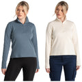 Two women model different long-sleeve tops one in a blue zip-neck top and the other in a cream zip-neck top both paired with dark pants against a plain white background.