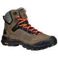 A rugged hiking boot is designed with tan and black materials featuring orange laces and a patterned side. It is equipped for outdoor activities with a sturdy Vibram sole for traction.