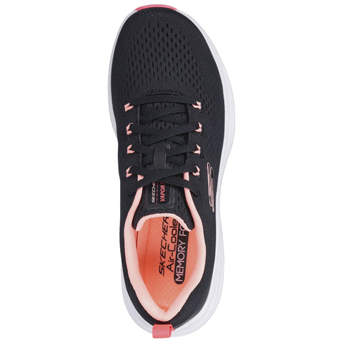 A sneaker sole is displayed with a black upper and a white base featuring a pink accent The sole shows a tread pattern designed for traction and support.