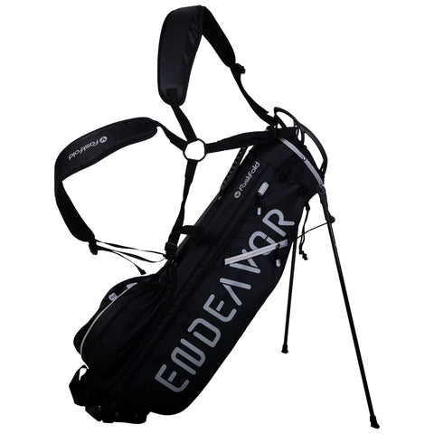 A black golf bag with adjustable straps stands upright on three legs showcasing the word "ENDEAVOR" in white letters a side pocket is visible for storage.