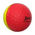 A two-toned golf ball featuring a red half and a yellow half with a dimpled surface displaying the brand name Srixon and the text Q-START TOUR on its body.